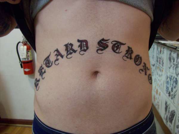 "Retard Strong" stomach rocker tattoo