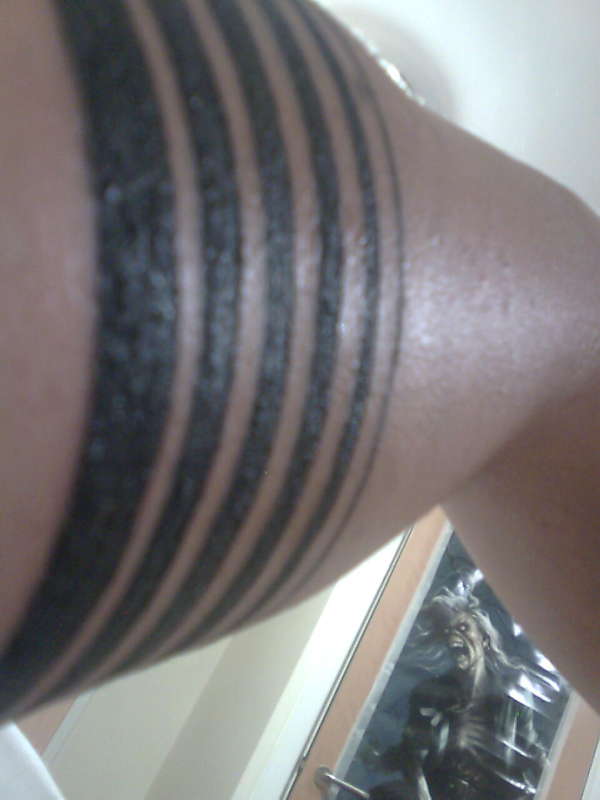 another view of six stripes in the arm tattoo