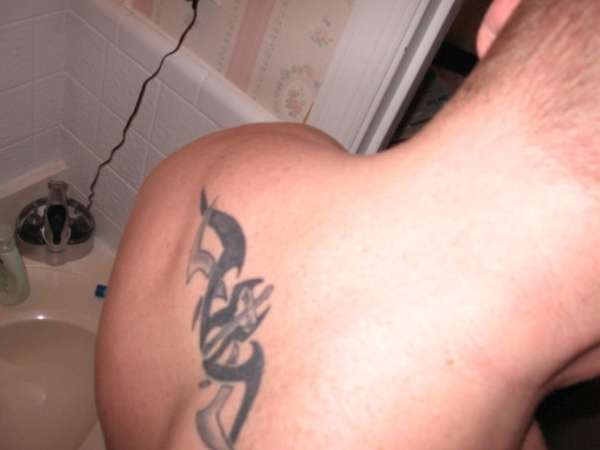 upper back cross with tribal tattoo
