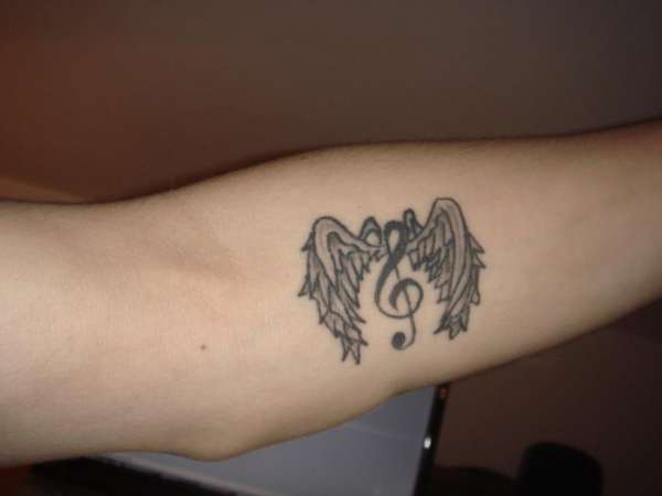 G clef with wings tattoo