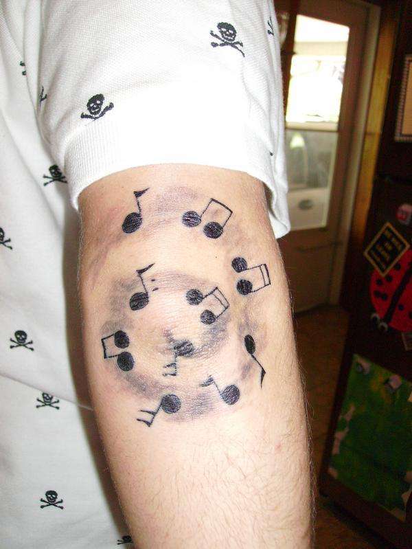 Music Notes on Elbow tattoo