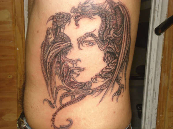 fighting dragons with face. tattoo