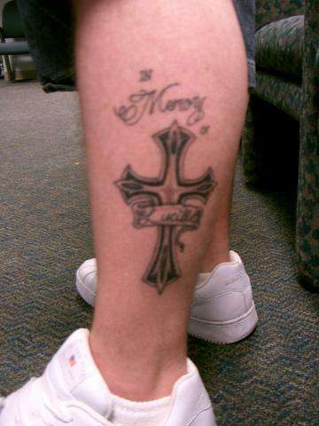 Cross on Right leg tattoo