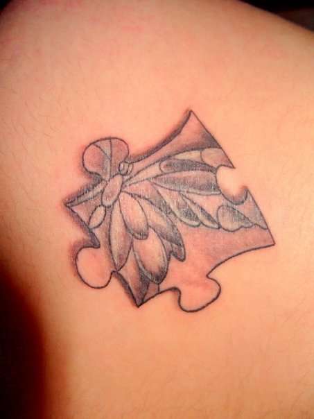 jigsaw piece with butterfly inside tattoo