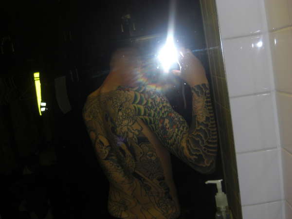 full back and left sleeve tattoo