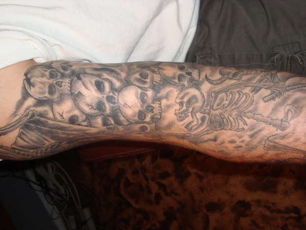 skeleton and faces tattoo