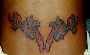 colored lower back floral tattoo