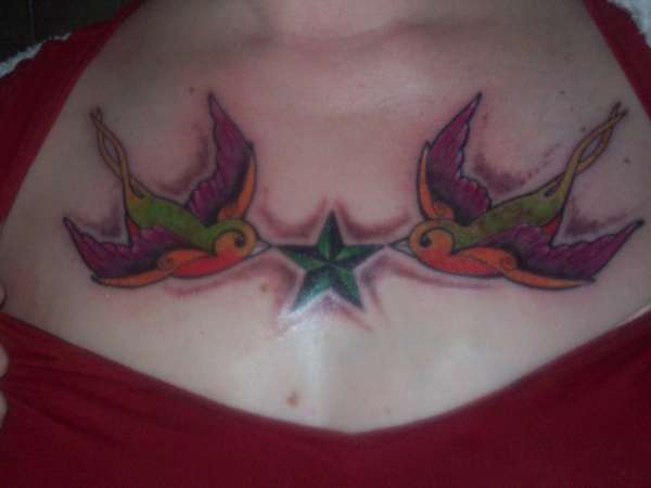 chest piece of swallows and nautical star tattoo