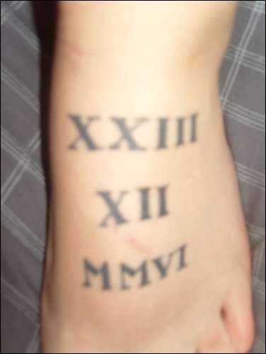 roman numerals on top of left foot tattoo