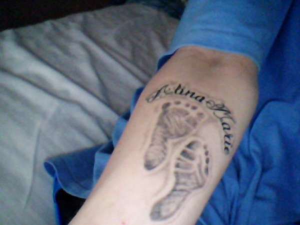 my daughters foot prints and name tattoo