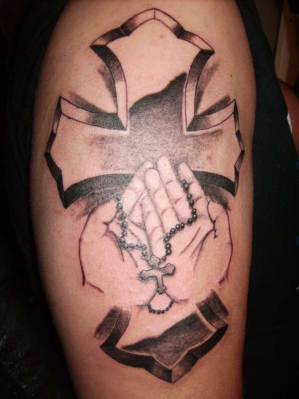 the classic cross with hands tattoo