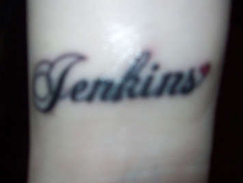 last name with a heart. tattoo