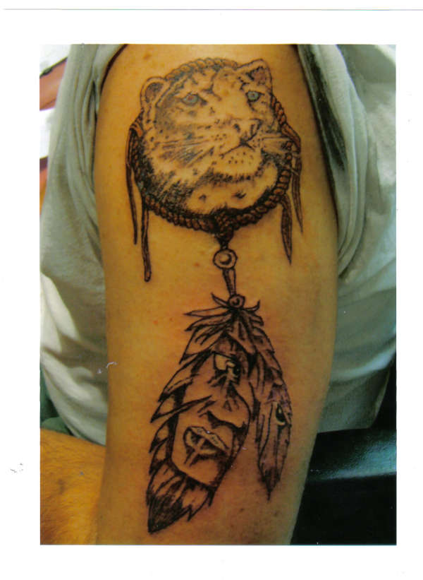 american indian face in feathers tattoo