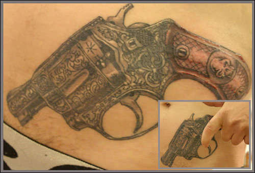 gun covering a star tattoo