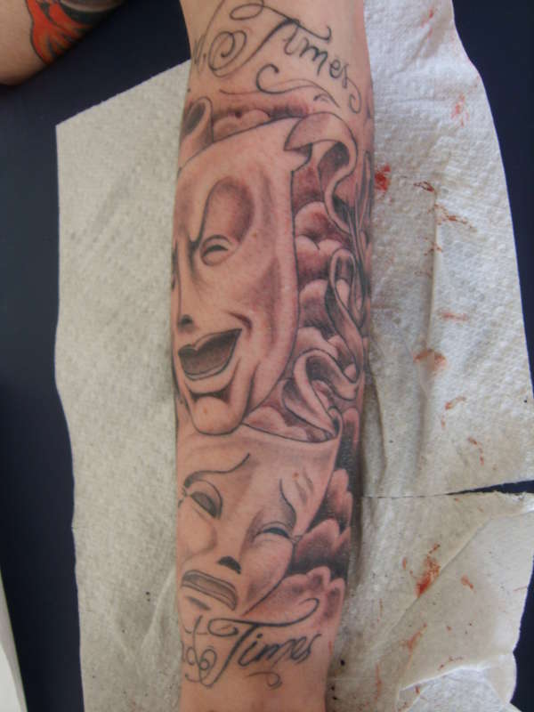 happy sad face sleeve tattoo