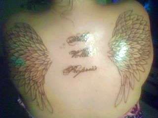 Beginning of my wings with Latin writing tattoo