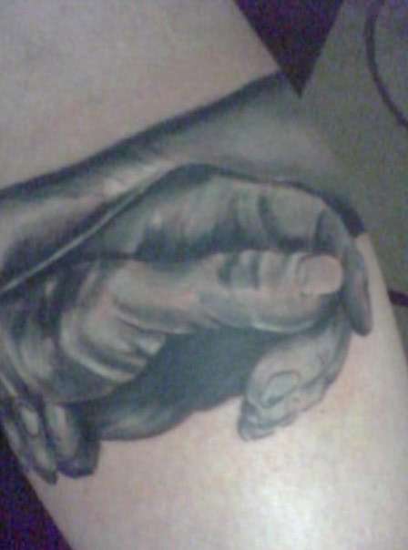 gripping hands tattoo