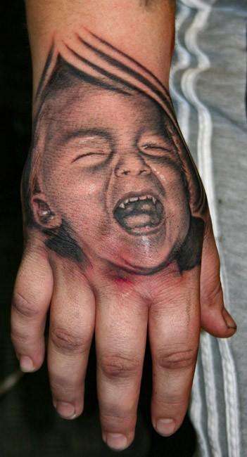 child portrait on hand tattoo