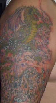 dragon on skulls tattoo