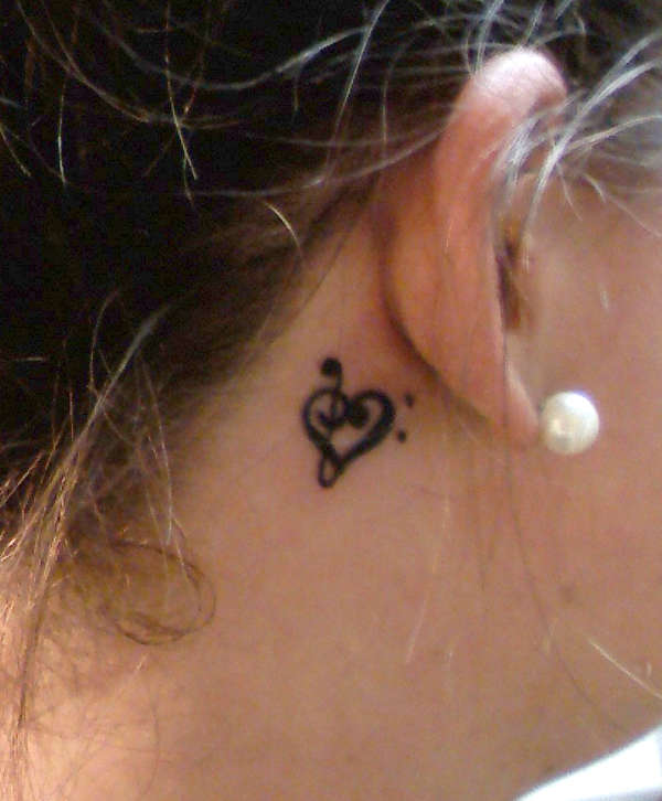 base & treble clef creation tattoo