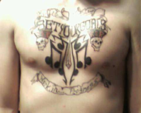 SET YOUR GOALS chest piece tattoo