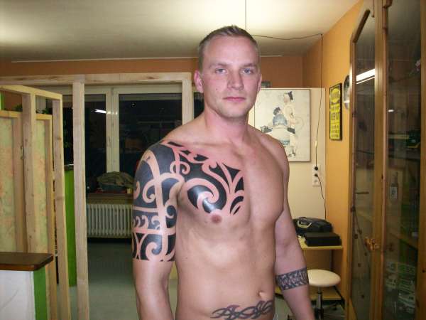 Chest  and arm piece tattoo