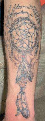 Dream catcher with peace pipe and feathers tattoo