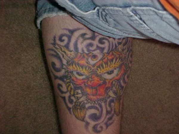 japanese mask on calf tattoo