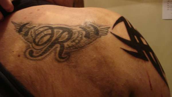 R in Angel's wings with quotes tattoo