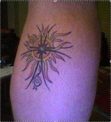 Sun, cross and treble clef tattoo