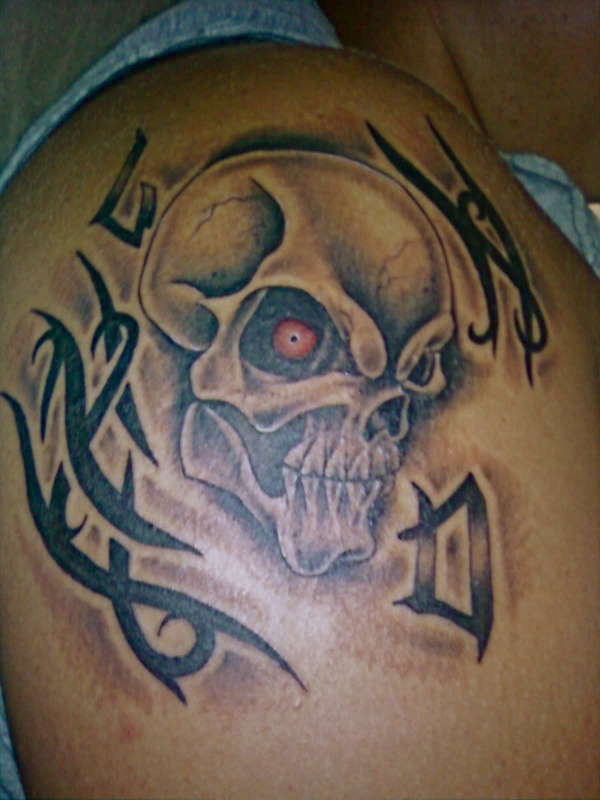 skull with tribal and my nick name tattoo