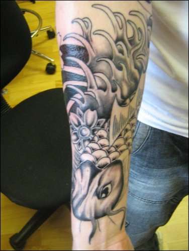 koi fish on arm tattoo