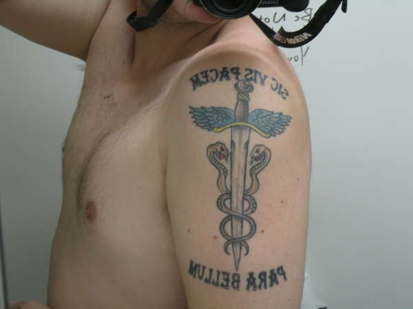 Latin Phrase On Arm tattoo