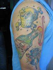 Skull, malitave cocktail, and oil drum tattoo