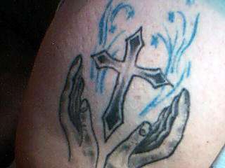 cross and hands tattoo