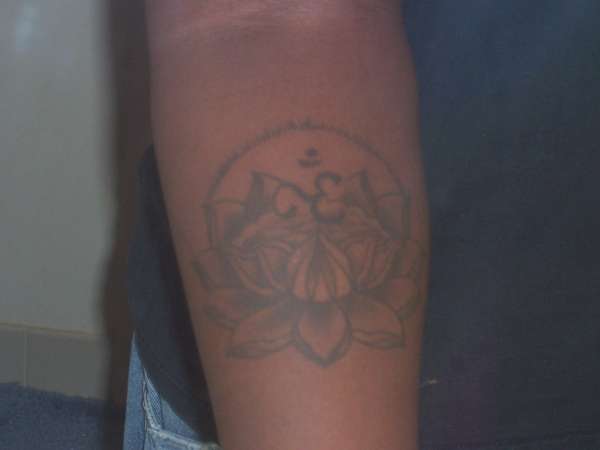 glowing ohm in lotus flower tattoo