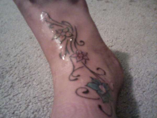 flowers on foot tattoo
