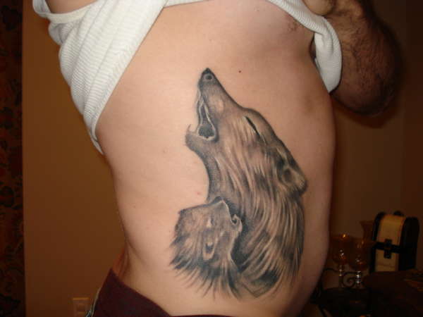 Wolf teaching a cub how to howl tattoo