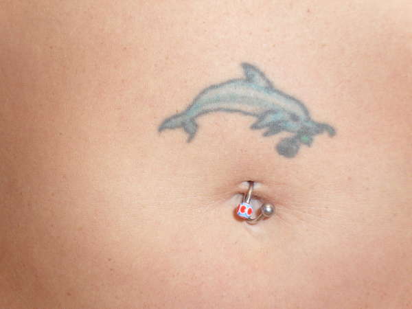 dolphin on stomach tattoo