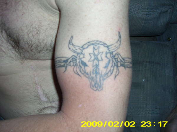 dull skull and band tattoo