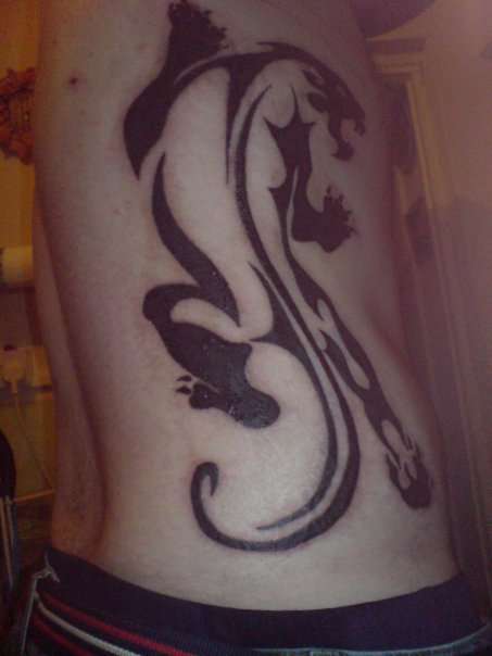 Panther on other ribs tattoo