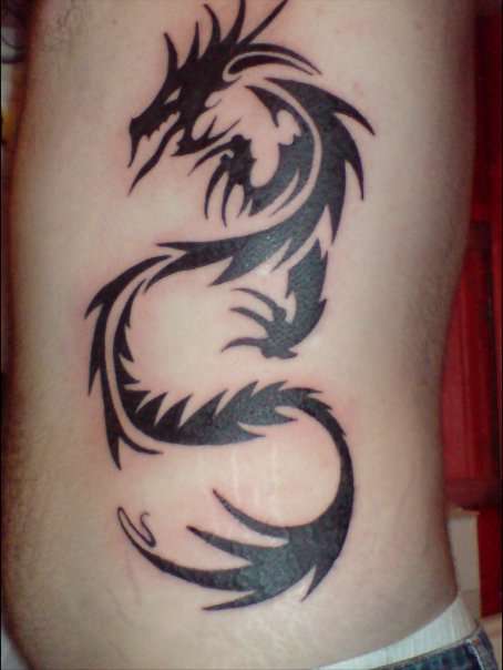 Tribal dragon on ribs tattoo