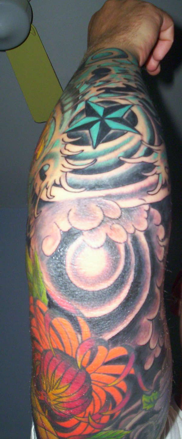 Lower half of sleeve tattoo