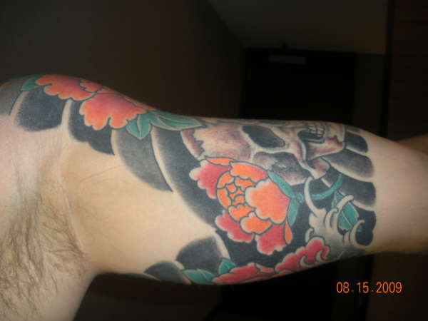 Red Flower under arm tattoo