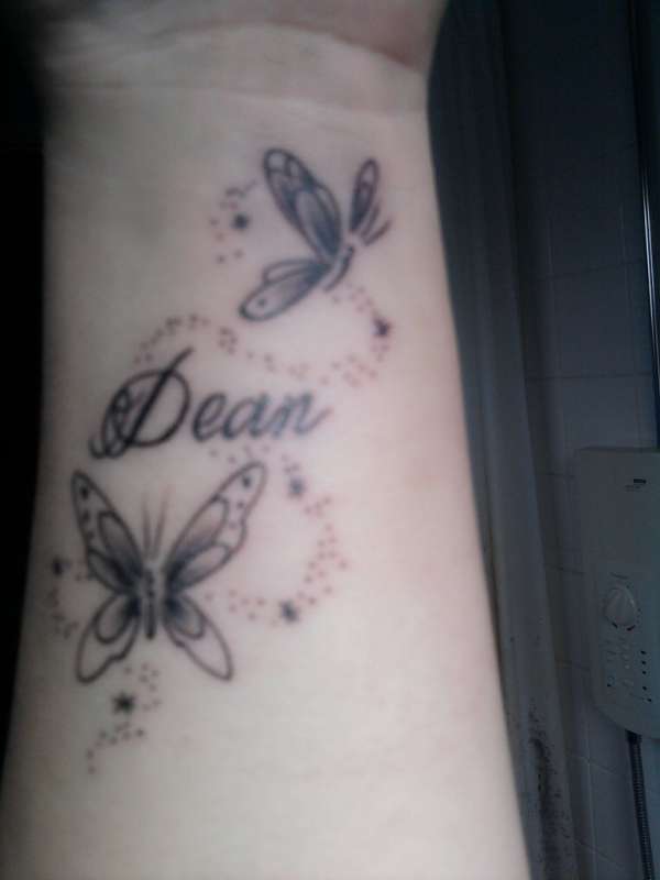 Butterfly and name tattoo on wrist