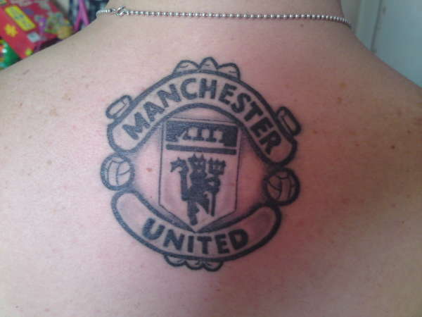 Manchester United badge tattoo