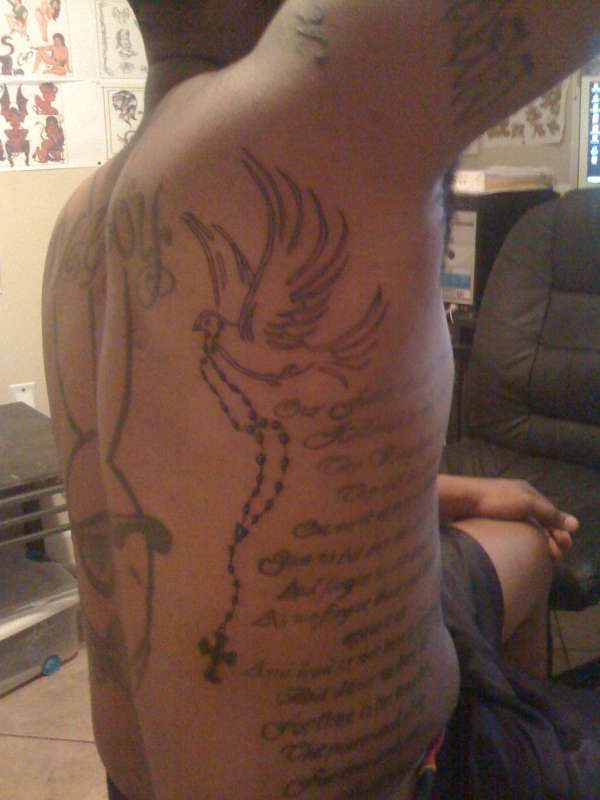 flying dove carring cross tattoo