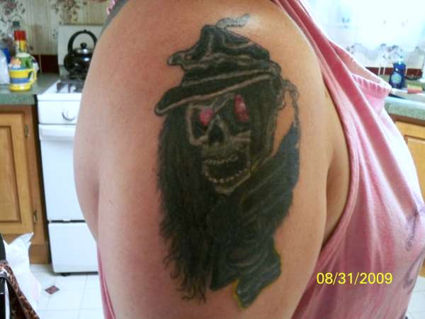 skeleton sporting his gun tattoo