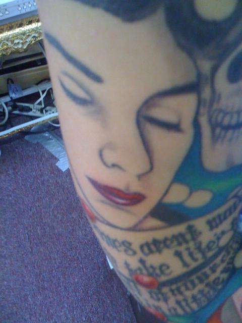 unfinished face on sleeve tattoo