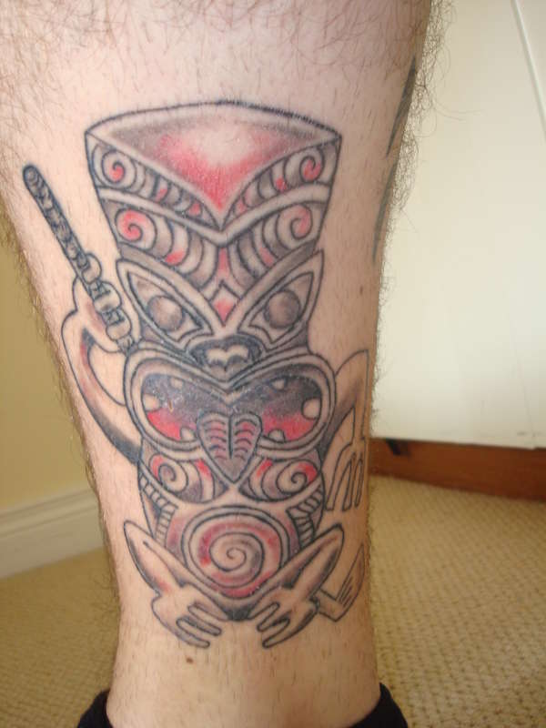 Tiki with golf club tattoo